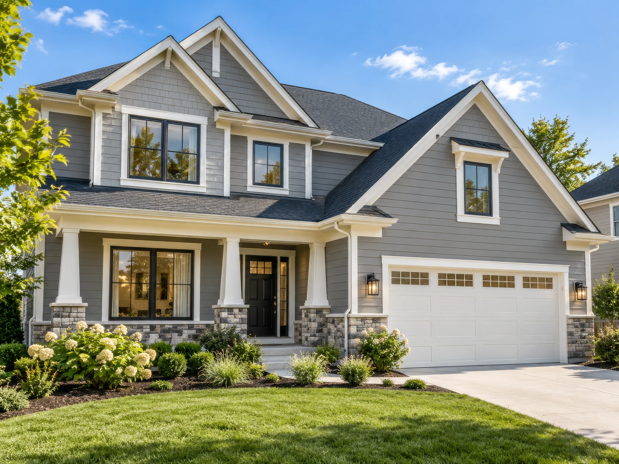 Illustrative gray Craftsman home with white siding trim, a landscaped front porch and an attached garage
